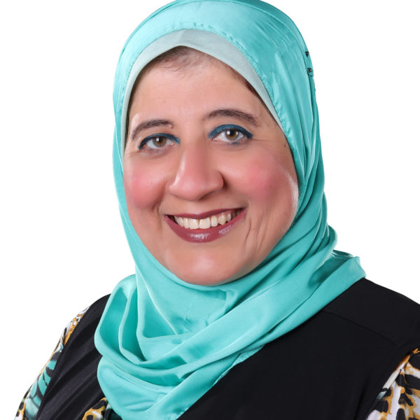 Head and shoulders photo of a woman wearing a blue headscarf and smiling